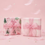 Two gifts wrapped in Pink Trees & Bows paper, one showing the pink gingham back, with sheer pink bows