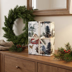 Gift wrapped in Red Barn Farmhouse paper with a cream ribbon, on a dresser beside a wreath